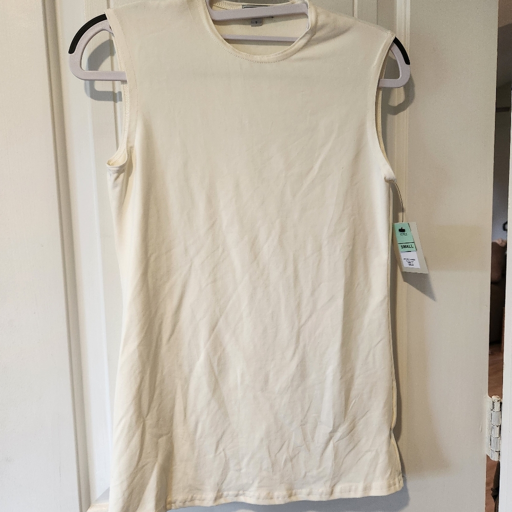 Cream colored, sleeveles top